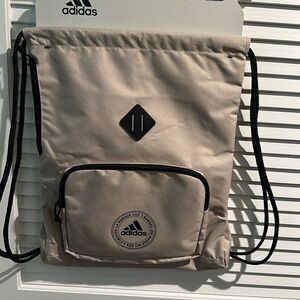 NWT Adidas Athletic Pull string bag with side and front pockets.